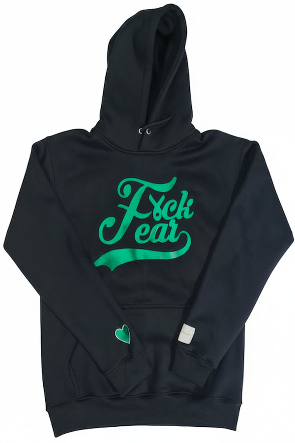  Black premium fleece hoodie featuring a bold kelly green "F*ck Fear" graphic on the front with a signature green heart embroidered on the sleeve by A Quiet Enemy. Mental health awareness statement apparel promoting courage, resilience, and healing.