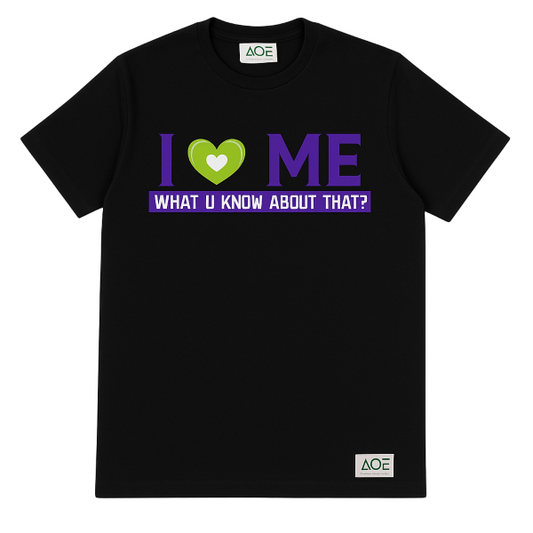 Black “I Love Me” t-shirt with green heart and purple typography, featuring bold self-love graphic and AQE woven label.