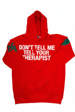 A bright red pullover hoodie with the phrase 'DON'T TELL ME TELL YOUR THERAPIST'