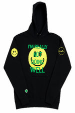 A black pullover hoodie with a graphic design on the front. The design features a large yellow smiley face with the text 'I'M REALLY NOT DOING WELL' in green.